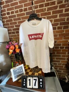 Levi's white graphic t-shirt featuring the iconic red batwing logo.